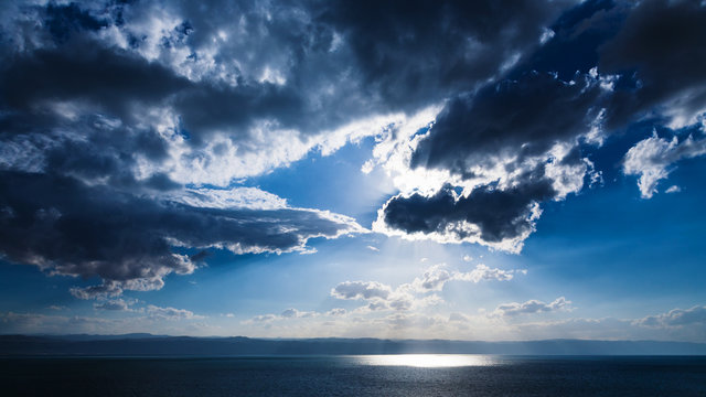 sunbeams passes through dark clouds over Dead Sea