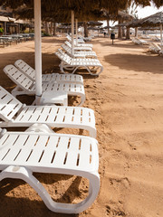 mpty sunbeds on beach in Aqaba city in winter