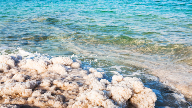 salt crystals on shore of Dead Sea in sunny day