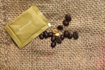 Brown sugar bag put on coffee sack or gunny sack brown color represent texture surface background.