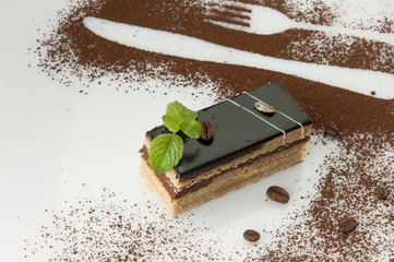 a piece of cake with sprinkled with powdered sugar on a white background