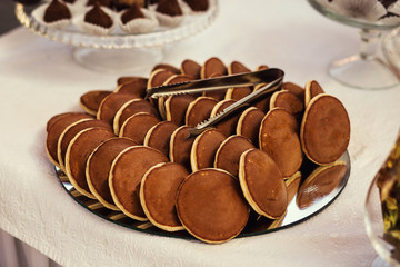 Sweet round cakes,fourchette, custard cakes, Sweet holiday buffet with cupcakes and other desserts, cathering in the restaurant, chocolate cakes