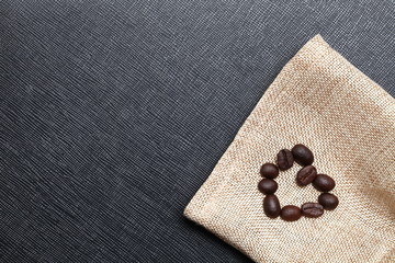 Coffee beans put on coffee sack or gunny sack brown color represent texture surface background.