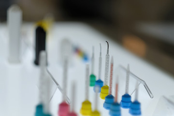The tip of the dental instrument on the illuminated display case