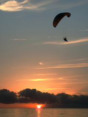 paragliding on the see at the sunset