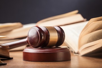 Wooden gavel and books.