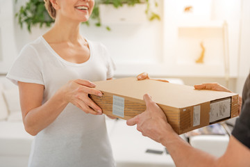 Happy laughing woman receiving parcel