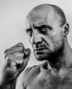 Strong, Ugly And Angry Man Shaking Fist, Bad Guy With Big Nose, Black Eye, Stony Unshaven Face, Old Boxer Dark Portrait