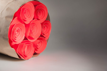 The flowers made of red paper. a red rose and a bouquet of flowers on a white background. copy space. background.