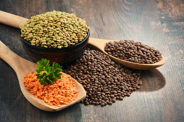 Composition with bowl of lentils on wooden table