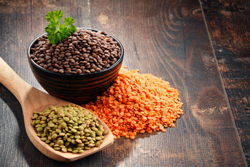 Composition with bowl of lentils on wooden table