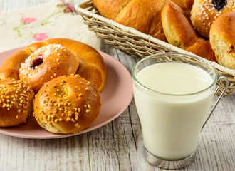 Healthy breakfast ingredients. Homemade fresh fragrant buns and milk . The food is rich in useful carbohydrates, vitamins and nutrients that are essential for health. 