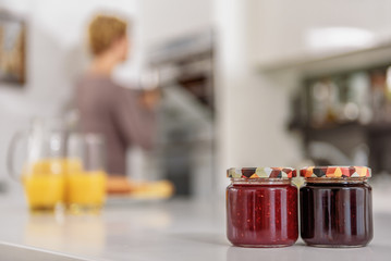 Cheerful housewife baking sweets in kitchen