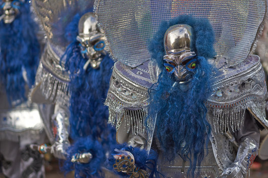 Masked Morenada dancers in ornate costumes parading through the mining city of Oruro on the Altiplano of Bolivia during the annual carnival.