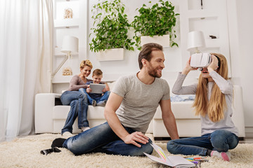 Joyful parents playing with their children at home