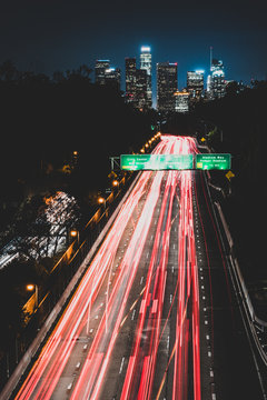Downtown Los Angeles at night view from highway leading to city