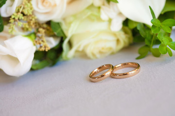 gold wedding rings on satin pillow