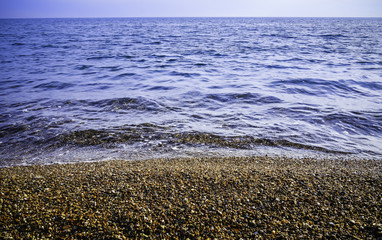 Beach with tiny peebles on the coast of Antalya City