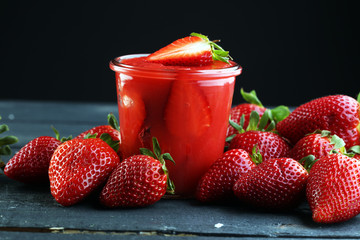 Fresh strawberry smoothie on wooden table