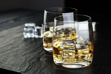 whiskey with ice on a wooden table