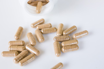 Powder of Thai herb in capsule out of bottle