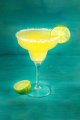 Lemon Margarita cocktails on vibrant turquoise with copyspace