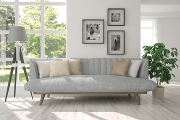 White room with sofa and green landscape in window. Scandinavian interior design. 3D illustration