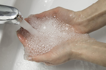 Hands under the tap water from a tap