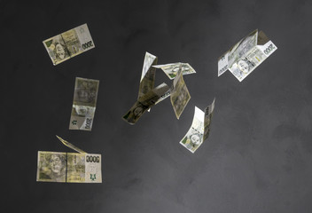 Czech money (2000 crowns banknotes) freeze in motion on black background