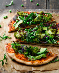 Vegan pizza with vegetables and pesto