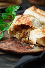 Toasted envelopes from Armenian thin pitta bread with filling of crushed boiled potatoes, fried...