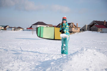 The girl prepares a springboard of snow for Snowkiting