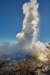 Fototapeta na wymiar Erupting geyser in sunlight