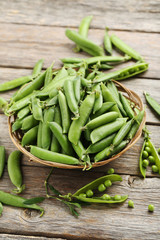Green peas on a grey wooden table