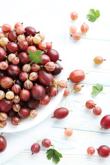 Gooseberries fruit on a white wooden table