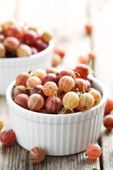 Gooseberries fruit on a grey wooden table