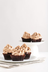 Tasty cupcakes on a white wooden table