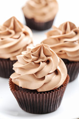 Tasty cupcakes on a white wooden table