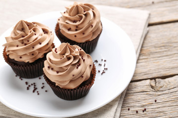Tasty cupcakes on a grey wooden table