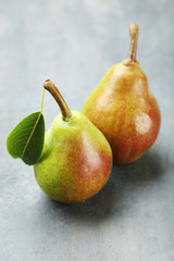 Ripe pears on grey wooden table