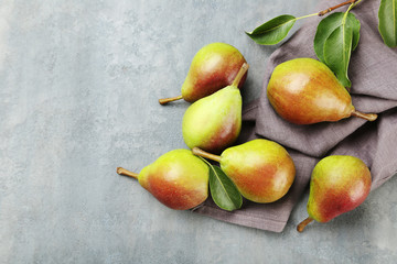 Ripe pears on grey wooden table