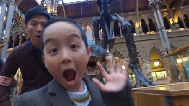  Happy family having fun in museum & video recording themselves