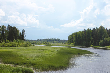 Landscape with river, forest, fields and blue sky