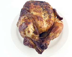 Front view of simple roast chicken on a platter.
