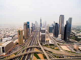 beautiful aerial view of futuristic city landscape with roads, cars and skyscrapers. Dubai, UAE