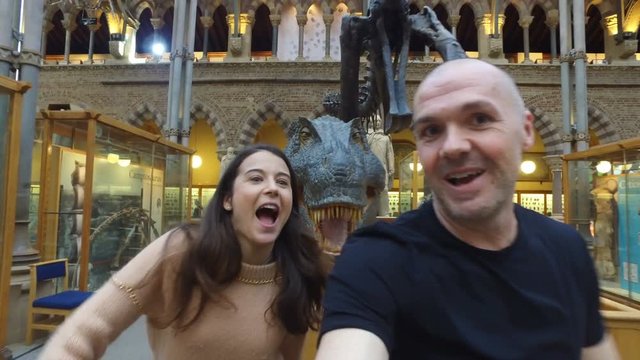  Happy family having fun in museum & video recording themselves