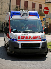 Ambulance on the city road during an emergency with blue sirens