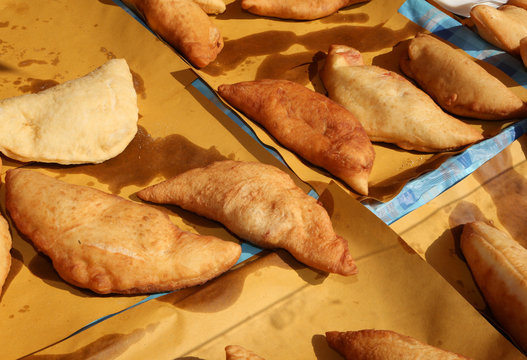 Big italian stuffed bread called Panzerotti  with tomato and che