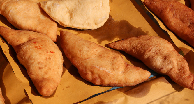 Big italian stuffed bread called Panzerotti  with tomato and che