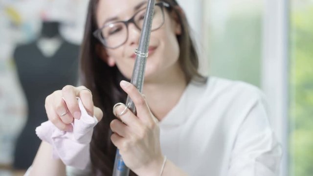  Jewelry designer working in studio using a tool to check size & quality of a ring. 